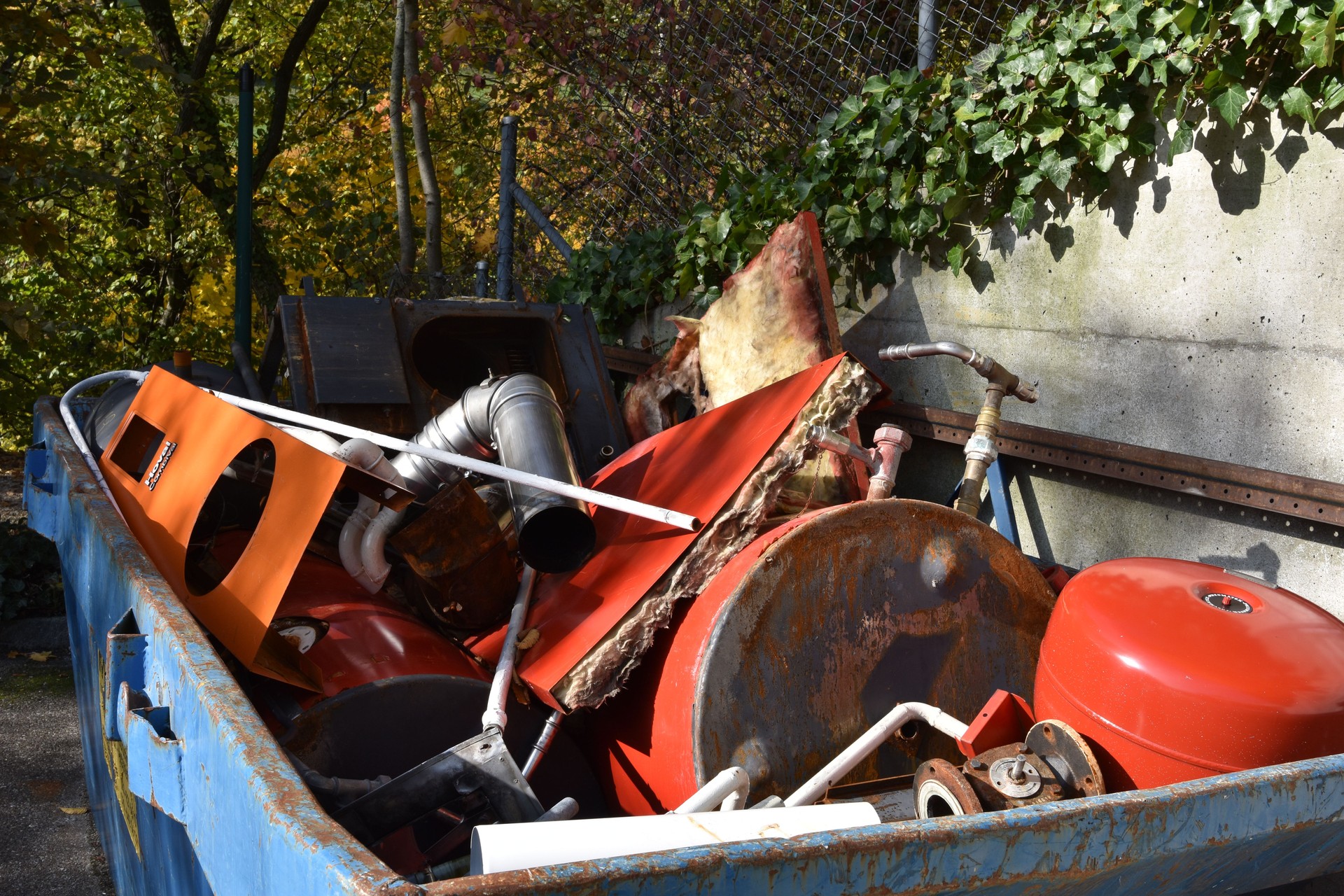 Scrap metal collected in a container in a community disposal place.